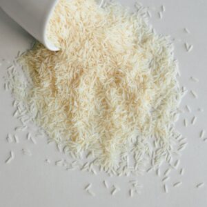 Long grain basmati rice spilling from a ceramic cup