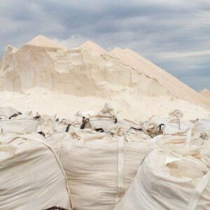 Jumbo export bags in front of a salt stockpile